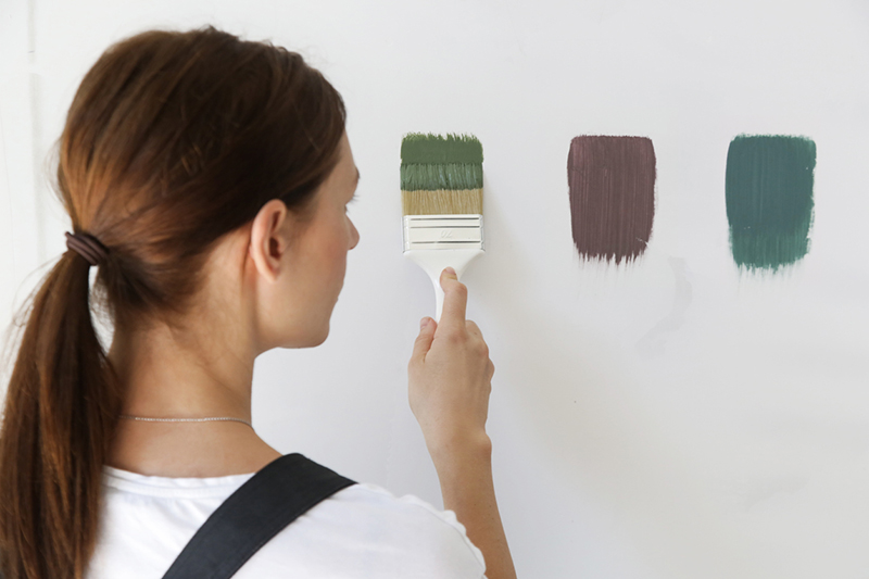 Women testing paint colors inside her home
